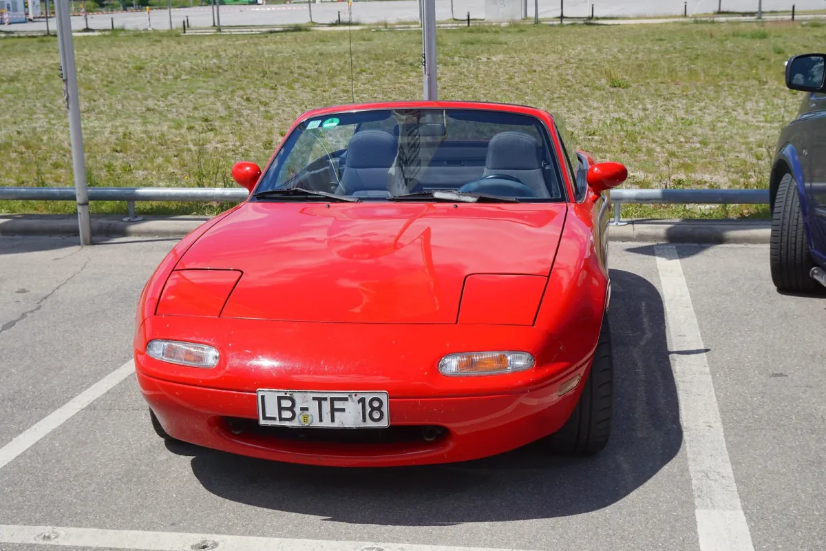 Pierwsza generacja MX-5 z przełomu lat 80. i 90. i jej znak firmowy — chowane reflektory, które wysuwały się z maski dopiero po zmroku. To od tego lekkiego auta zaczął się najlepiej sprzedający się roadster świata.