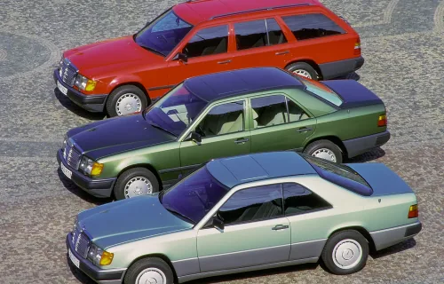 Coupé C124 z 1987 roku w ujęciu bocznym — i cała jego tajemnica na widoku. Brak słupka B sprawia, że po opuszczeniu szyb bok auta otwiera się w jeden nieprzerwany prześwit. Ten efekt kosztował inżynierów z Sindelfingen miesiące pracy nad sztywnością nadwo